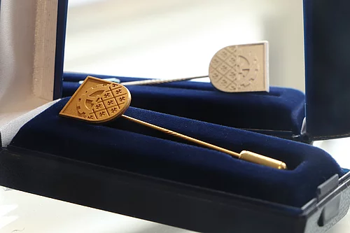 Eine Ehrennadel der Stadt Glinde in Gold ist eine Darstellung des Wappens.