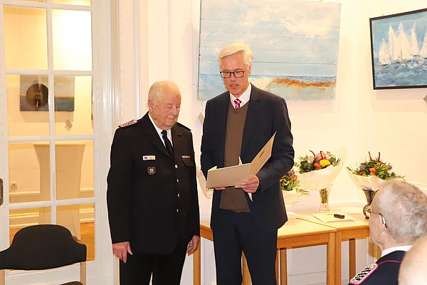 Rainhard Zug übergibt eine Urkunde an Horst Kindt.