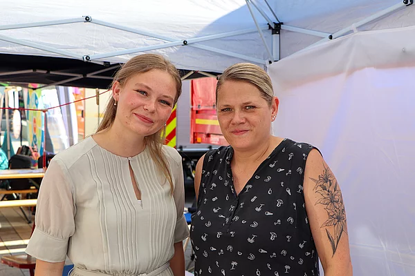 Menschen an einem Stand.