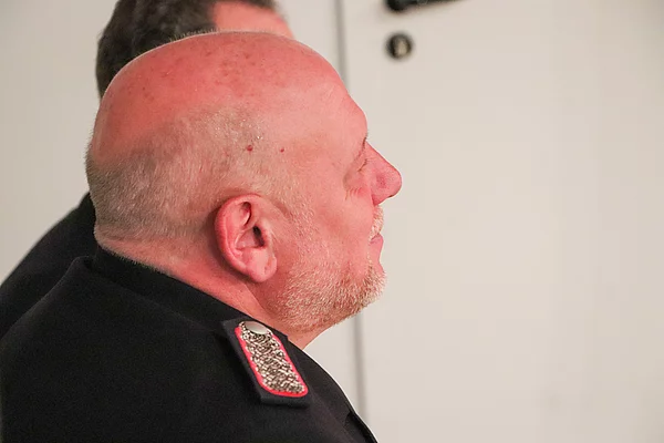 Wehrführer Michael Weidemann schaut zu einem Redner beim Festakt der FFW Glinde. Foto: Stadt Glinde
