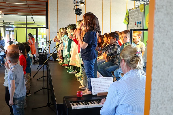 Kinder singen auf der Bühne.
